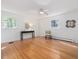 Bedroom featuring hardwood floors, two windows, and a ceiling fan at 203 Wood Cir, Chapel Hill, NC 27514