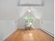 Bedroom with hardwood floors, ceiling fan, wainscotting and a sunlit window with backyard view at 203 Wood Cir, Chapel Hill, NC 27514