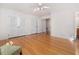 Spacious bedroom boasts hardwood floors, white trim, ceiling fan, and closet with bi-fold doors at 203 Wood Cir, Chapel Hill, NC 27514