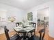 Bright dining room showcasing hardwood floors and an open layout with a pass-through to the kitchen at 203 Wood Cir, Chapel Hill, NC 27514