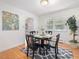 Cozy dining area with hardwood floors, a black table set, and a view to the outside at 203 Wood Cir, Chapel Hill, NC 27514