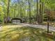 Home exterior featuring a two-car garage, mature trees, and a long driveway at 203 Wood Cir, Chapel Hill, NC 27514