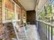 Inviting porch with classic rocking chairs, perfect for enjoying the wooded surroundings at 203 Wood Cir, Chapel Hill, NC 27514