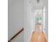Bright hallway featuring hardwood floors and a view of a sunlit room through an open doorway at 203 Wood Cir, Chapel Hill, NC 27514