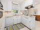 Bright kitchen features white cabinetry, stainless steel appliances, and a window above the sink at 203 Wood Cir, Chapel Hill, NC 27514