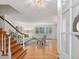 Bright living room featuring hardwood floors, a staircase, and a large window overlooking the yard at 203 Wood Cir, Chapel Hill, NC 27514