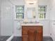 Modern shower includes gray tiled floors, a clear glass door, white tiled walls, and chrome grab bars at 203 Wood Cir, Chapel Hill, NC 27514