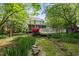 Beautiful backyard with a screened porch and patio surrounded by green lawn and trees at 204 Black Forest Dr, Clayton, NC 27527