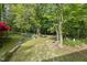 Scenic backyard with stone borders and lush grass creates a tranquil and inviting outdoor space at 204 Black Forest Dr, Clayton, NC 27527