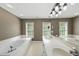 Bathroom features a large tub and a double vanity sink, and natural light from the windows at 204 Black Forest Dr, Clayton, NC 27527