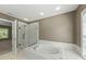 Bathroom features a tub with shower, and natural light from the window at 204 Black Forest Dr, Clayton, NC 27527
