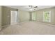 Bedroom features neutral carpet, natural light from two windows, ceiling fan and access to another room at 204 Black Forest Dr, Clayton, NC 27527