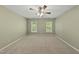 Bedroom features a ceiling fan, neutral carpet, and natural light from the two windows at 204 Black Forest Dr, Clayton, NC 27527