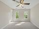 Bedroom with neutral carpet, ceiling fan and natural light from the windows at 204 Black Forest Dr, Clayton, NC 27527