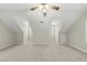 Spacious bonus room with sloped ceilings, plush carpet, and a ceiling fan at 204 Black Forest Dr, Clayton, NC 27527