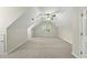 Spacious bonus room with sloped ceilings, plush carpet, and a ceiling fan at 204 Black Forest Dr, Clayton, NC 27527