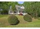 Inviting two-story home with a covered front porch and a well-manicured lawn at 204 Black Forest Dr, Clayton, NC 27527