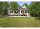 Lovely two-story home featuring a spacious front porch and manicured lawn at 204 Black Forest Dr, Clayton, NC 27527