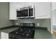 Close up of kitchen appliances, including microwave and gas stovetop at 204 Black Forest Dr, Clayton, NC 27527
