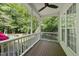 Cozy covered porch with wooden floors and a beautiful view of the surrounding nature at 204 Black Forest Dr, Clayton, NC 27527