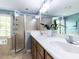Bright bathroom with double vanity, glass shower, and tiled walls at 204 Flint Point Ln, Holly Springs, NC 27540