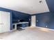 Large bedroom featuring built-in shelving, closet, and blue walls with neutral carpet at 204 Flint Point Ln, Holly Springs, NC 27540