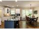 Beautiful kitchen featuring granite countertops, a central island with seating, and a bright, open dining area at 204 Flint Point Ln, Holly Springs, NC 27540