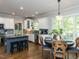 Bright kitchen with stainless steel appliances, custom cabinets, granite counters, and a breakfast nook with large windows at 204 Flint Point Ln, Holly Springs, NC 27540