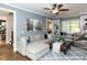 Comfortable living room with a large sectional sofa, built-in shelving, and inviting window seat at 204 Flint Point Ln, Holly Springs, NC 27540