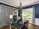 Stylish home office with a barn door, large windows, and modern chandelier, perfect for working from home at 204 Flint Point Ln, Holly Springs, NC 27540
