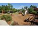 Community playground featuring swings, slides, and climbing structures surrounded by lush landscaping at 204 Flint Point Ln, Holly Springs, NC 27540