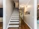 Elegant staircase with hardwood steps, white risers, and wooden handrail leading to the second floor at 204 Flint Point Ln, Holly Springs, NC 27540