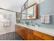 Bathroom features a double sink vanity, wood cabinetry, and blue tiling at 205 Wood Cir, Chapel Hill, NC 27514
