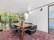 Open dining area with large windows, a modern table set, and an adjacent kitchen area at 205 Wood Cir, Chapel Hill, NC 27514