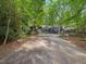 Long driveway leading to a unique modern home, surrounded by lush greenery at 205 Wood Cir, Chapel Hill, NC 27514