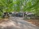 Stunning modern home with unique architecture, featuring a brick driveway and lush greenery at 205 Wood Cir, Chapel Hill, NC 27514