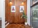 Hallway with wood paneled walls, parquet floors, and art pieces that bring character to the room at 205 Wood Cir, Chapel Hill, NC 27514
