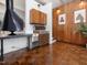 Hallway featuring a black retro fireplace, built-in cabinets, and unique parquet flooring throughout the house at 205 Wood Cir, Chapel Hill, NC 27514