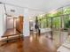 Bright living room featuring hardwood floors, fireplace, and wall of windows showcasing outdoor views at 205 Wood Cir, Chapel Hill, NC 27514