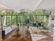 Bright living room with floor-to-ceiling windows offering stunning views of the surrounding forest and vaulted ceilings at 205 Wood Cir, Chapel Hill, NC 27514