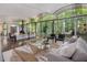Modern living room features a unique ceiling, large windows, and views of the wooded landscape at 205 Wood Cir, Chapel Hill, NC 27514