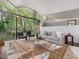 Bright living room featuring modern furniture, a plush rug, and expansive windows with views of the lush outdoors at 205 Wood Cir, Chapel Hill, NC 27514