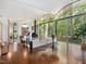 Living room with floor-to-ceiling windows offering forest views, a modern fireplace, and hardwood flooring at 205 Wood Cir, Chapel Hill, NC 27514