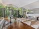 Bright living room with floor-to-ceiling windows offering stunning views of the surrounding forest and vaulted ceilings at 205 Wood Cir, Chapel Hill, NC 27514