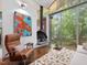 Bright living room featuring a modern fireplace, floor-to-ceiling windows, and a beautiful abstract painting at 205 Wood Cir, Chapel Hill, NC 27514