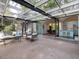 Spacious patio with comfortable seating, a glass roof, and view into the kitchen and dining area at 205 Wood Cir, Chapel Hill, NC 27514