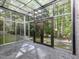Bright sunroom with glass ceilings and walls that provide an uninterrupted view of the surrounding landscape at 205 Wood Cir, Chapel Hill, NC 27514