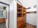 Walk-in closet with wooden shelves and drawers, providing ample storage space, adjacent to the bathroom at 205 Wood Cir, Chapel Hill, NC 27514