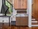 Vintage wet bar area with wood paneling, retro cabinet, and views of the wooded outdoor space at 205 Wood Cir, Chapel Hill, NC 27514