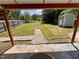 Backyard view from covered porch featuring grass, shed, and a wood privacy fence at 2101 S Roxboro St, Durham, NC 27707